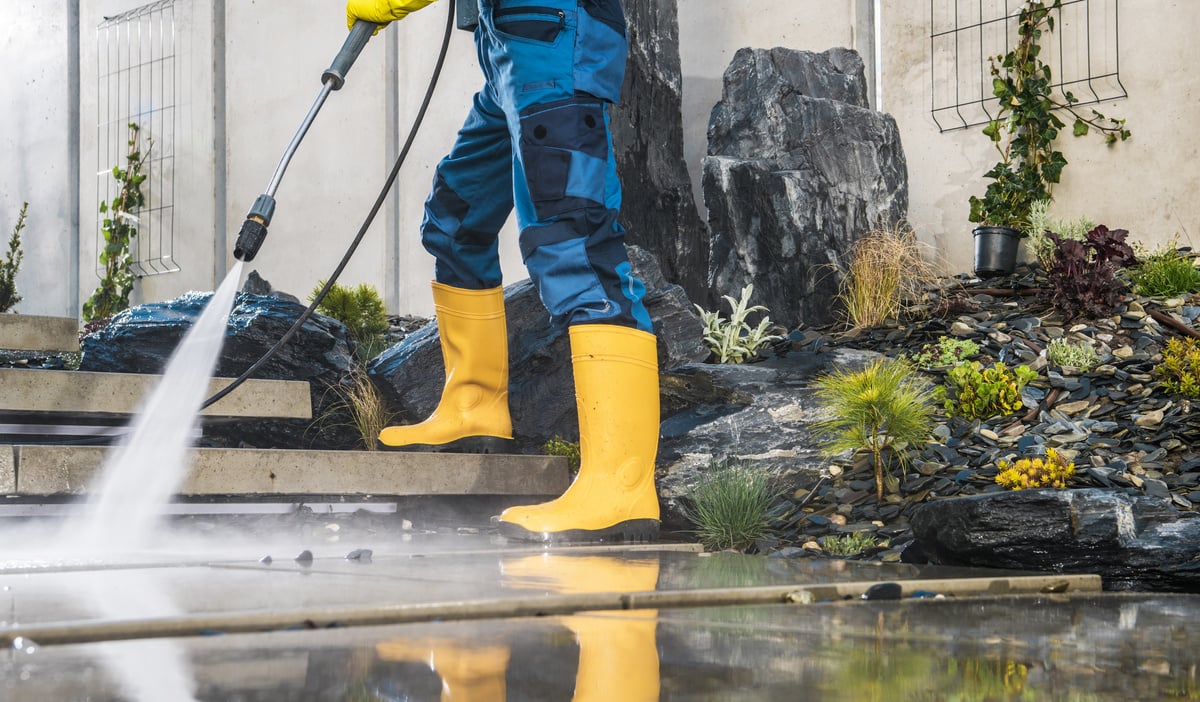 Men Pressure Washing His Garden Architectural Concrete Elements